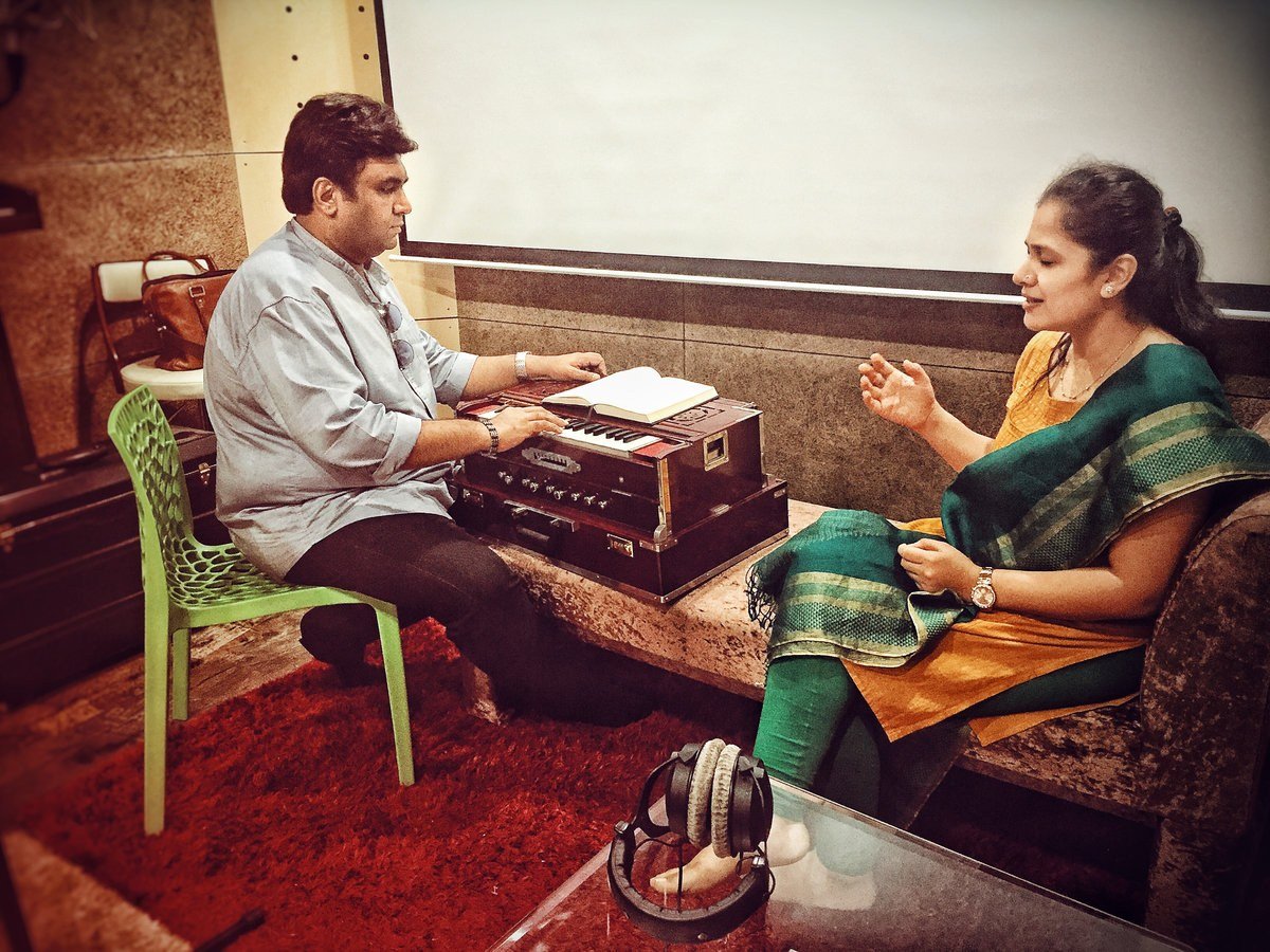 Artists rehearsing with a harmonium in a recording studio